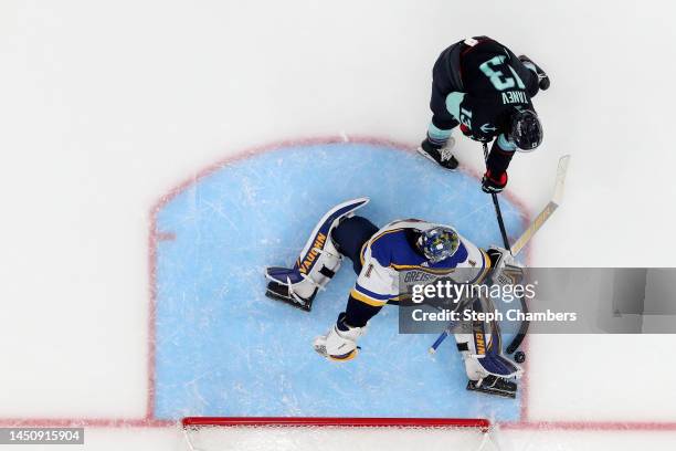 Thomas Greiss of the St. Louis Blues makes a save against Brandon Tanev of the Seattle Kraken on a penalty shot during the third period at Climate...