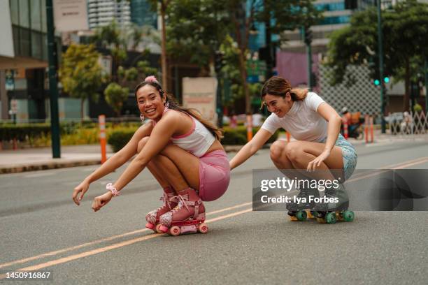 young filipino women rollerskating in the city - philippines friends stock pictures, royalty-free photos & images