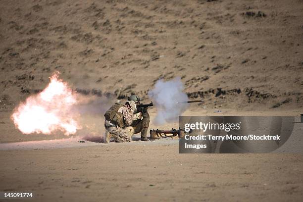 a soldier fires a rocket-propelled grenade launcher. - rocket launcher stock pictures, royalty-free photos & images