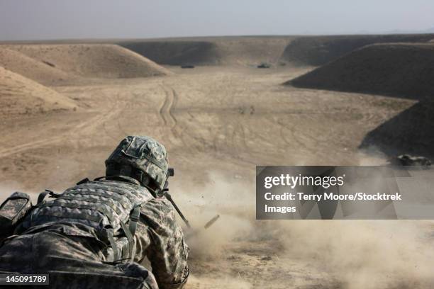 a u.s. army soldier fires a barrett m82a1 rifle on a firing range, kunduz, afghanistan. - operation enduring freedom stock pictures, royalty-free photos & images