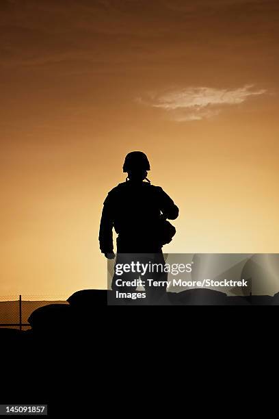 partially silhouetted u.s. marine on a bunker in northern afghanistan. - operation enduring freedom stock pictures, royalty-free photos & images