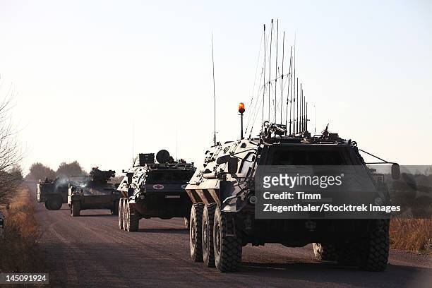 a convoy of german army tpz fuchs armored personnel carriers. - armored personnel carrier stock pictures, royalty-free photos & images