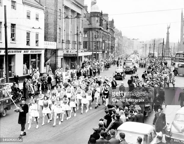 The rag headed by the Majorettes, makes its way through surging crowds in the Haymarket, to make the annual tour of the city during rag week 1960.