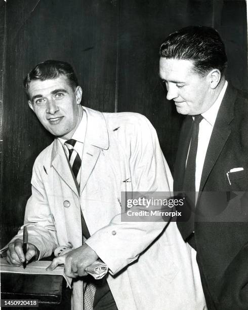 Willie Cunningham signs on for Dunfermline, watched by manager Jock Stein. Circa 1960.
