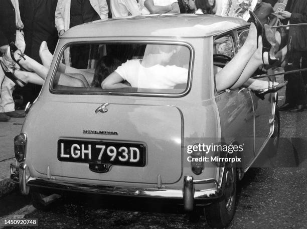 Fifteen girls pack themselves into a mini car. 21st July 1966.