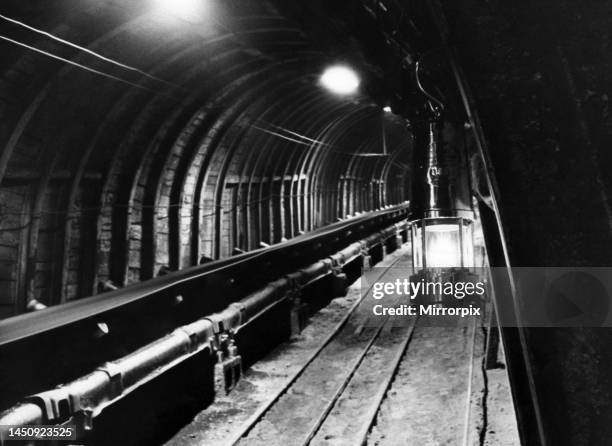 Pit tunnel showing conveyer belt and a 'Davey' lamp at a coal mine in Newstead, Nottinghamshire. April 1962.