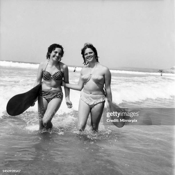 Women body boarding in the surf at Newquay June 1960.