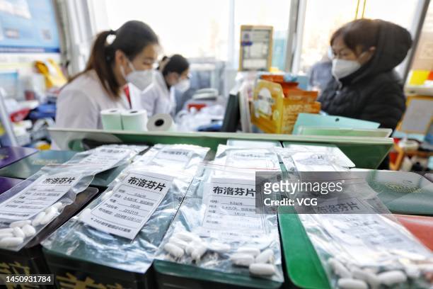 People purchase ibuprofen at a pharmacy on December 21, 2022 in Tai'an, Shandong Province of China. Local pharmacies in Tai'an open packages of...