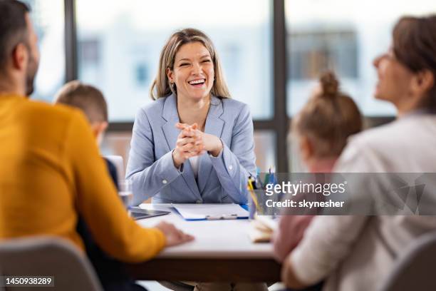 female school principal talking to a family about children's education in the office. - principal stock pictures, royalty-free photos & images