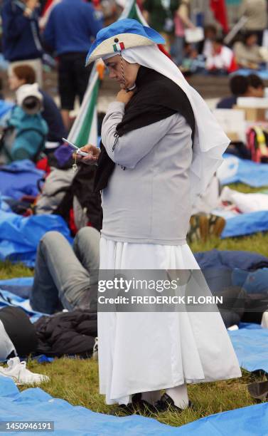 An Italian nun reads message on her cellphone at Marienfeld in Kerpen, near Cologne 20 August 2005 where pilgrims will meet Pope Benedict XVI. Pope...