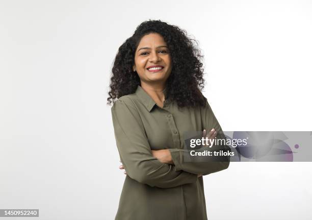 portrait of woman with arms crossed - portrait indoors stock pictures, royalty-free photos & images