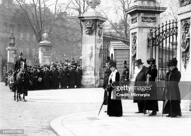 World War One - Queen Alexandra stands outside the gates of Buckingham Palace to receive the salute from a marchpast of troops 1919.