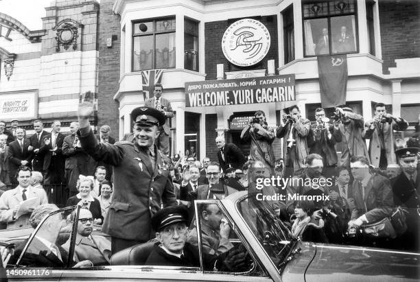 Soviet cosmonaut Yuri Gagarin waves from a car outside the headquarters of the Amalgamated Union of Foundry Workers after receiving a medal. 12th...