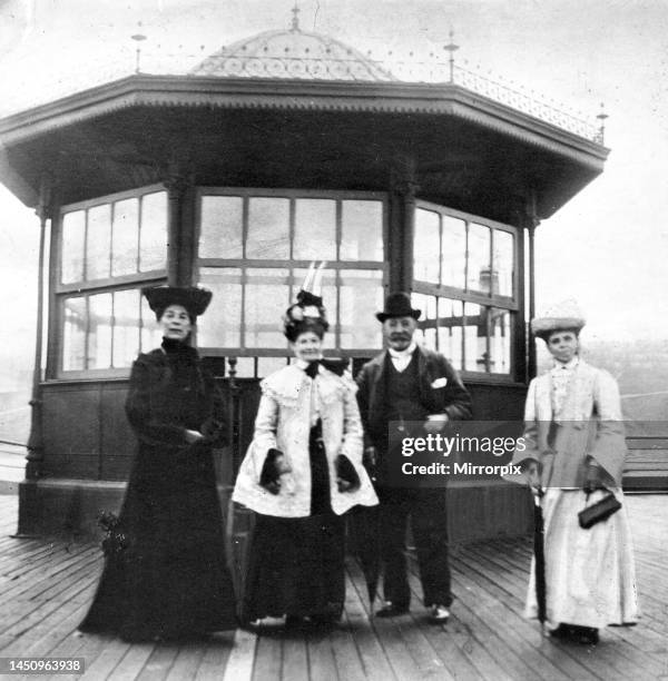 Women and men wearing edwardian fashion during a trip to the seaside at Roker Beach circa 1900.