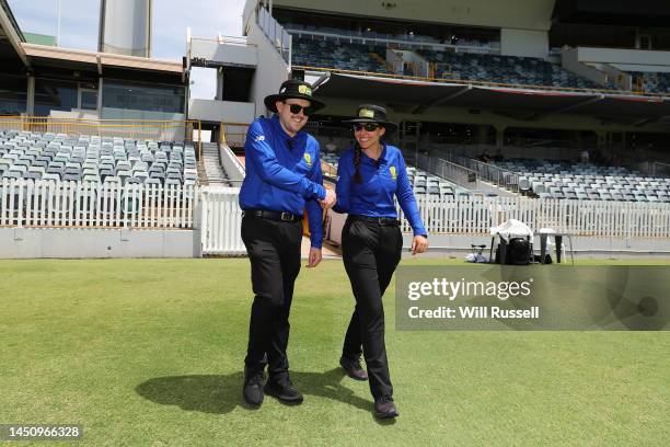 Umpires Jamie Thomas and Ashlee Gibbons shake hands as they walk out onto the field during the WNCL match between Western Australia and Queensland at...