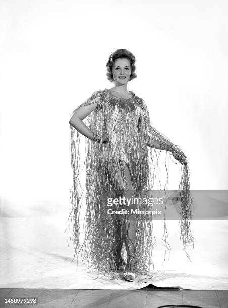 Roma Reeves wears a grass dress. Circa 1963.