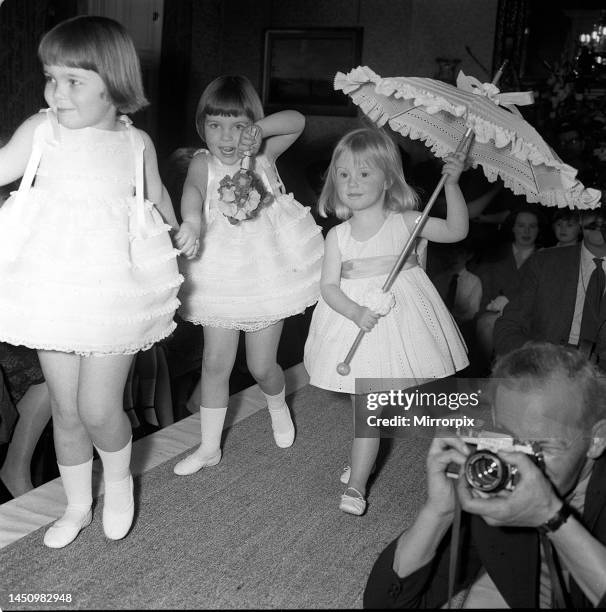 Children's fashion 1962: Children model American designer clothes. Cathryn Harrison walking down the catwalk in a little dress with a parasol. 23rd...