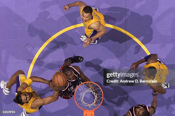 Kelvin Cato of the Houston Rockets puts one down as the Lakers defense stands and watches during the second half of action at Staples Center in Los...