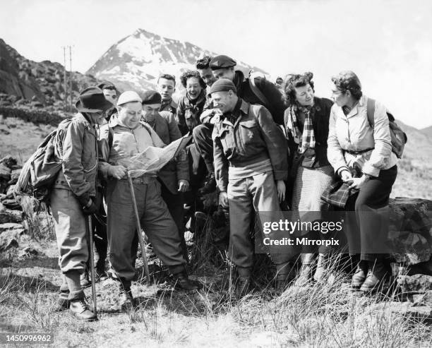 Hikers planning their route through the Scottish mountains. April 1951.