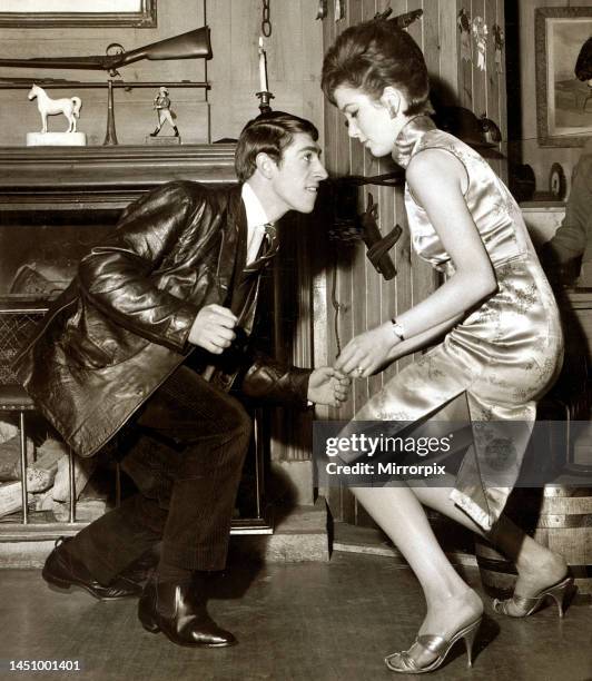 Young couple dancing the twist in their living room. May 1963.