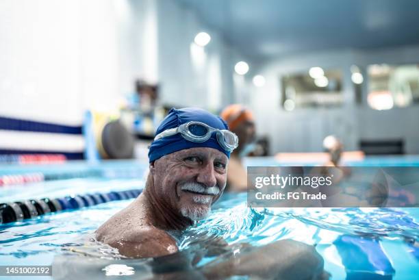 portrait of a senior man at swimming pool - baby boomer stock pictures, royalty-free photos & images