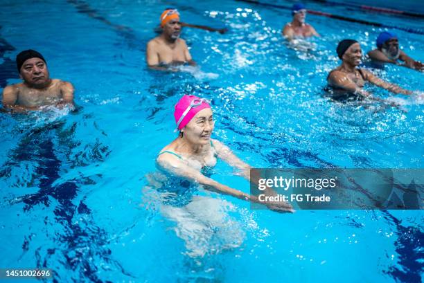 senior people exercising at swimming pool - aquarobics stock pictures, royalty-free photos & images