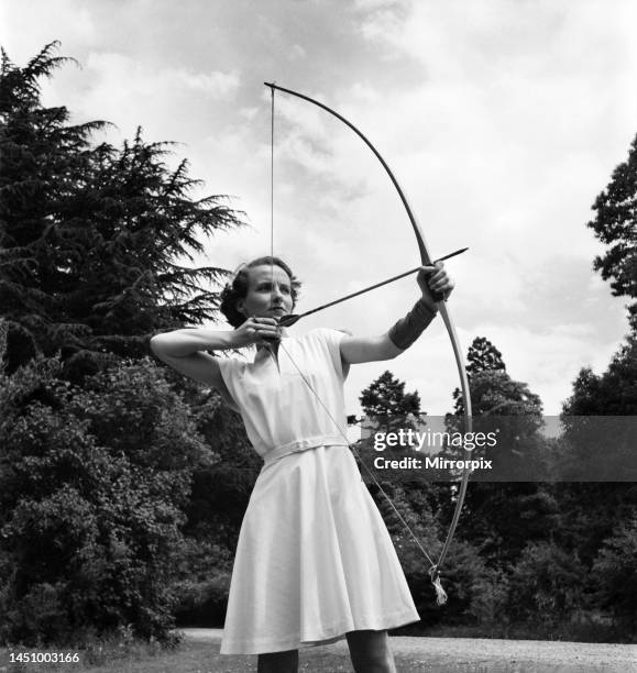 Bisham Abbey Physical recreation centre. A woman on the lawns in front of the Abbey get in a little archery practice. June 1952.