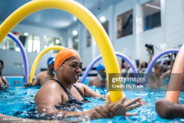 teacher explaining exercises at swimming pool - hydrotherapy stock pictures, royalty-free photos & images