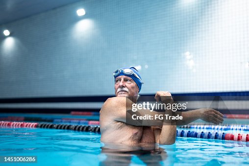 Senior man stretching at swimming pool Senior man stretching at swimming pool
