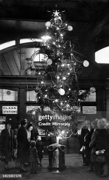 Brightening up Victoria station, Manchester, is this Christmas Tree, which was switched on by Mr R. C. Flowerdew, the District Passengers...