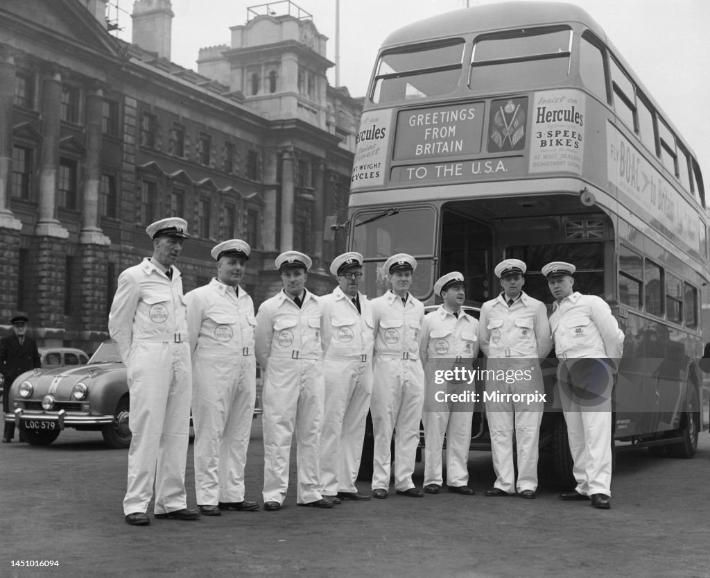 Milkmen stand in front of a London Double Decker bus