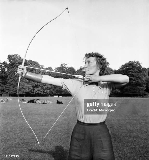 Bisham Abbey Physical recreation centre. A woman on the lawns in front of the Abbey get in a little archery practice. June 1952.