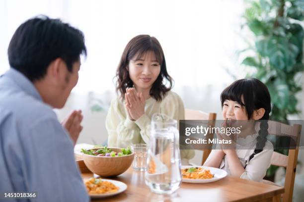 family surrounding the dining table - meal stock pictures, royalty-free photos & images