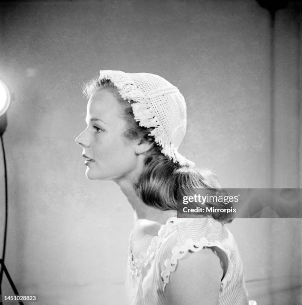 Woman models a crochet cap. July 1952.