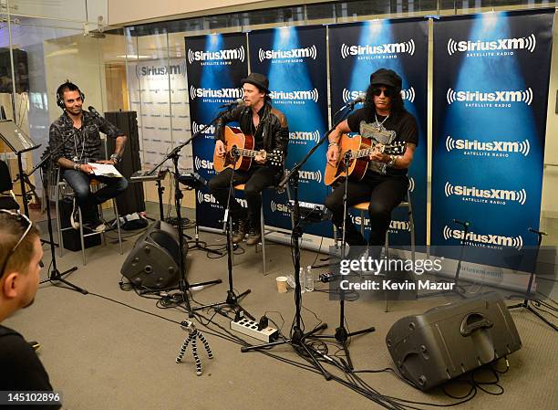 Sirius XM host Jose Mangin talks with Myles Kennedy and Slash on SiriusXM's Octane in the SiriusXM Studio on May 23, 2012 in New York City.