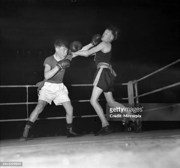 Sport Boys Club Amatuer BoxingLeft to right R. Perry, of the Canton P. F. Club, Wales, throwns a terrific left which connects with the jaw or T....