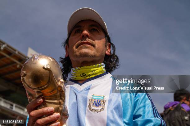 An Argentinian fan holds a world cup trophy fans during the live transmission of the FIFA World Cup Qatar final between Argentina and France in...