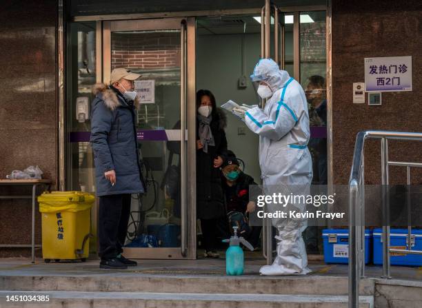 Medical worker wears PPE as he assists patients at a fever clinic treating COVID-19 patients on December 21, 2022 in Beijing, China. Chinas capital...