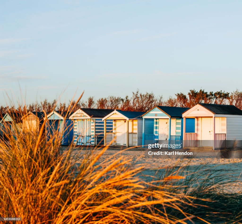 A sunset view of beach huts, UK