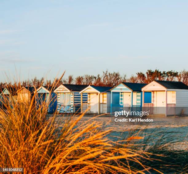 a sunset view of beach huts, uk - beach house stock pictures, royalty-free photos & images