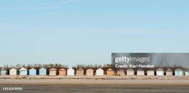 a sunset view of beach huts, uk - beach panoramic stock pictures, royalty-free photos & images