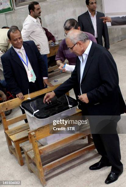 Egyptian presidential candidate and former prime minister Ahmed Shafiq casts his ballot at a polling station in Cairo on May 23, 2012. Egyptians...