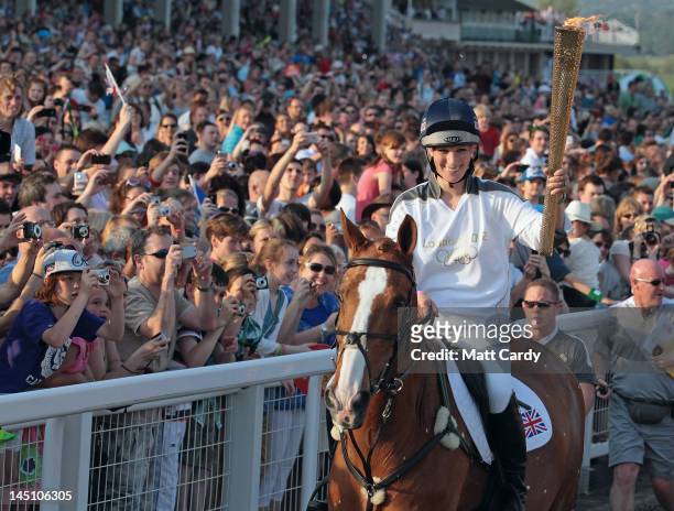 Olympic torchbearer Zara Phillips arrives on her horse Toy Town as she brings Olympic flame to Cheltenham Racecourse on May 23, 2012 in Cheltenham,...