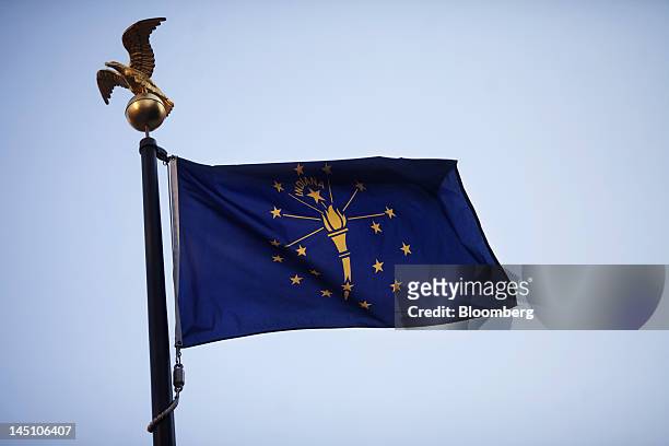 The state flag flies over the Indiana State House in Indianapolis, Indiana, U.S., on Sunday, May 20, 2012. The Indiana agency that supervised...