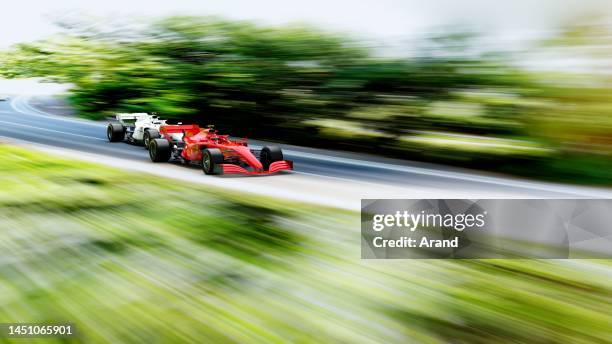 red race car leading on a race track - motorsport stock pictures, royalty-free photos & images