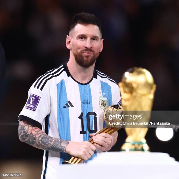 Lionel Messi of Argentina looks at the FIFA World Cup trophy following the FIFA World Cup Qatar 2022 Final match between Argentina and France at...