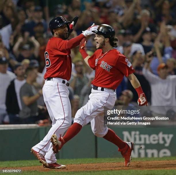 Andrew Benintendi and Eduardo Nunez celebrate after scoring on a Mitch Moreland single in the 7th inning of the Red Sox vs. Yankees MLB game at...