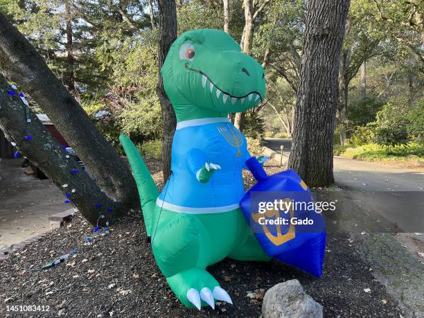 Inflatable Hanukkah dinosaur lawn ornament with menorah and dreidel during the Hanukkah holiday, Lafayette, California, December 18, 2022. Photo...