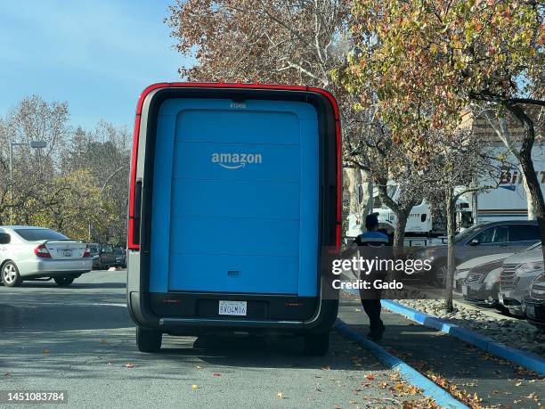 An Amazon electric delivery truck, developed by electric vehicle maker Rivian, makes deliveries in a residential neighborhood in Pleasant Hill,...