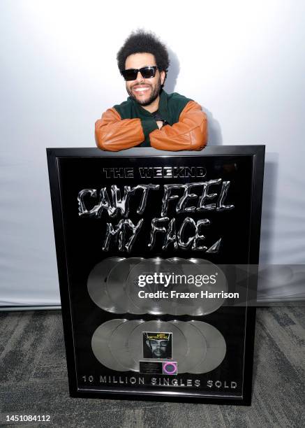 The Weeknd poses with the RIAA Diamond Certification plaque for the song “Can’t Feel My Face” backstage during the "After Hours Til Dawn" Tour at...